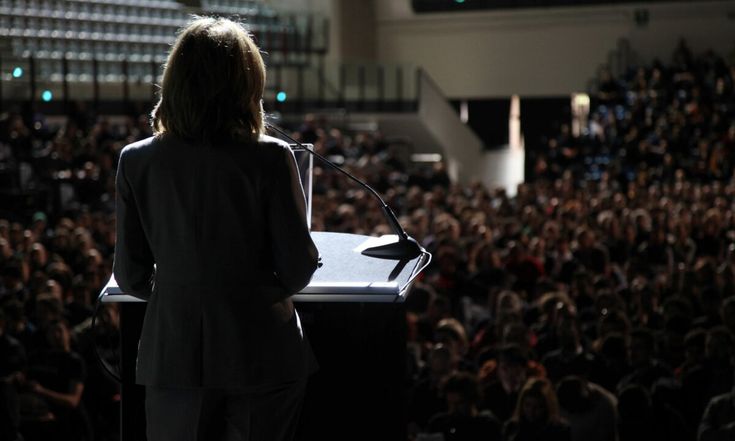 Speaker addressing a large audience.